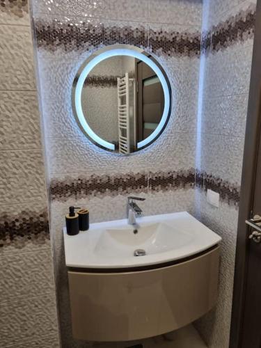 a bathroom with a sink and a mirror at Luxury Apartments in Bacău