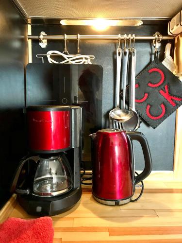 two red appliances sitting on top of a kitchen counter at Eleana Apartments in Hersonissos