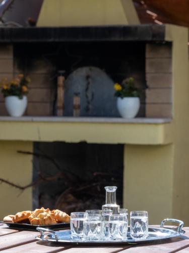 a table with glasses and a plate of food at Grey House "by Checkin" in Karteros