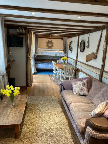 a living room with a couch and a table at Hideaway at Botany Bay in Broadstairs