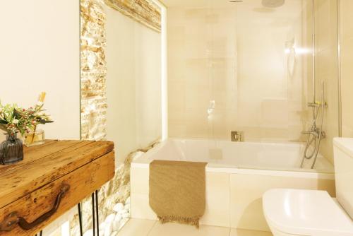 e bagno con vasca, servizi igienici e lavandino. di Casa Deluxe Herreros ad Alcalá de Henares