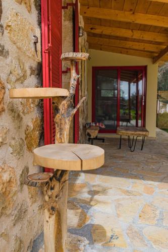 a wooden chair sitting outside of a building at Dreamy Stone House in Pesádha
