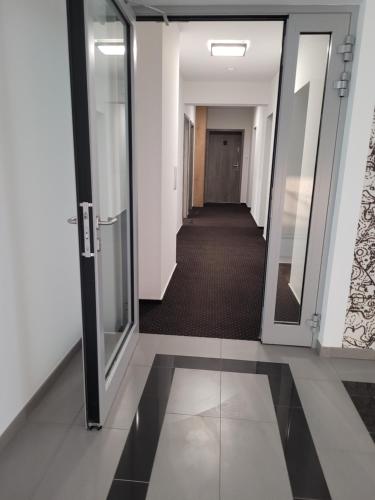 a corridor of an office building with a hallway at Apartament Portowy in Wilkasy