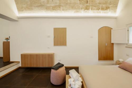 a room with a bed and a couch and cabinets at San Giovanni Vecchio - Residenza in Matera