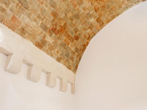 a close up of the underside of a brick bridge at San Giovanni Vecchio - Residenza in Matera