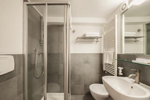 a bathroom with a shower and a toilet and a sink at San Giovanni Vecchio - Residenza in Matera