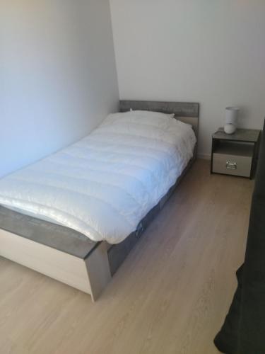 1 dormitorio con 1 cama y suelo de madera en La Terrasse en Mers-les-Bains