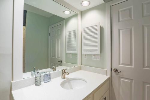 a bathroom with a sink and a mirror at Riverhouse in Johns Island