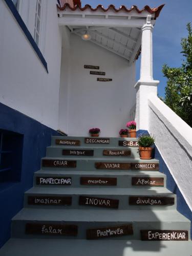 a set of stairs with words on them in front of a building at Casa da Livraria - Boutique da Cultura in Avis