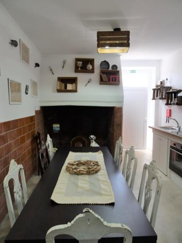 a dining room with a table and a fireplace at Casa da Livraria - Boutique da Cultura in Avis
