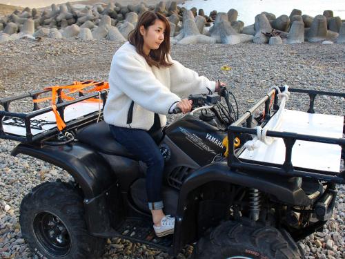 a woman sitting on a four wheeler vehicle at MARINE-Q in Inami