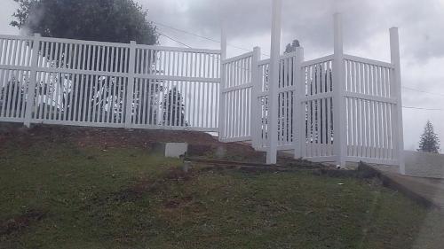 a white fence on top of a hill at 2C Edward Place in Ballito