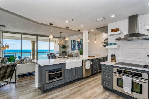 a kitchen with an island and a view of the ocean at Beach Club 604 in Pensacola Beach