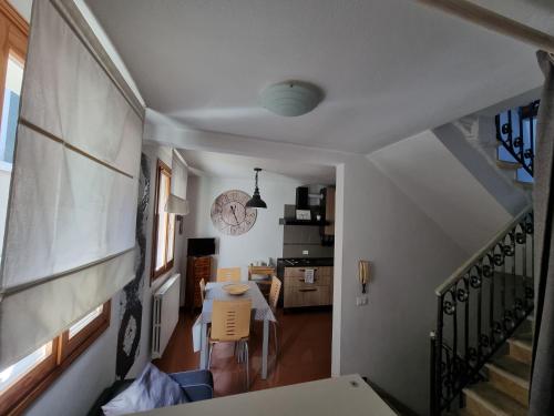 a hallway with a table and chairs in a house at Residenza al Volto in Venice