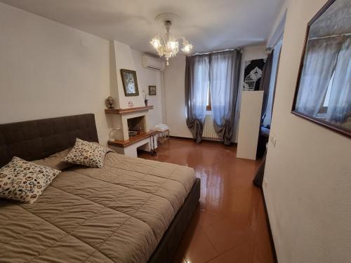 a bedroom with a bed and a fireplace in it at Residenza al Volto in Venice