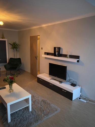 a living room with a tv and a table at Oasis House in Hunedoara