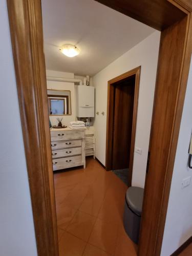 a bathroom with a sink and a dresser in a room at Residenza al Volto in Venice