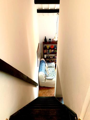 a hallway with a stairway with a couch in a room at A vacation on a private island in Carloforte