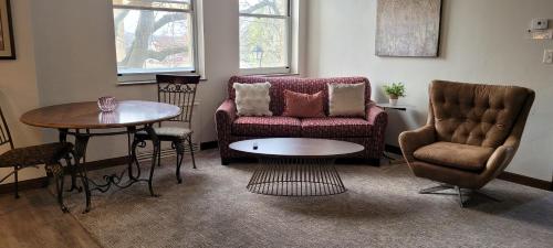 a living room with a couch and a table and chairs at Hotel Phillips in Bartlesville