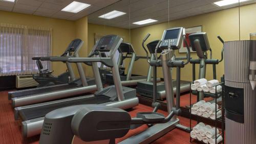 a gym with several tread machines and a mirror at Sonesta Select Atlanta Duluth in Duluth