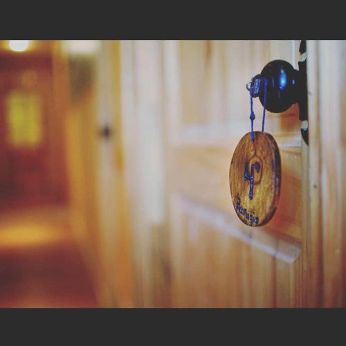 a clock hanging on a wall in a room at Roble Austral Hostal in Coihaique