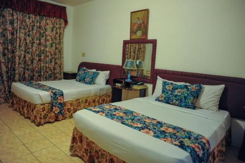 Postel nebo postele na pokoji v ubytování Glorianna Hotel