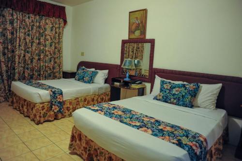 Glorianna Hotel tesisinde bir odada yatak veya yataklar