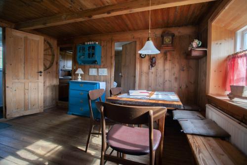 Skálavík的住宿－The Real Faroese Experience，小屋内的厨房配有桌椅