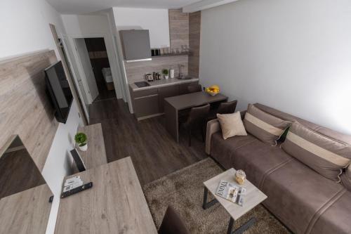 a living room with a couch and a table at Hany Sweet in Niš