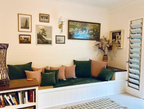 a living room with a couch and some pictures on the wall at Pandanus Place - with Bicycles in Port Douglas