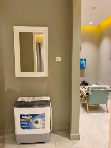 a room with a counter and a mirror and a sink at Al Rawdha Hotel Apartments in Sharjah
