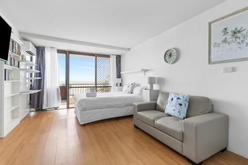 a living room filled with furniture and a window at Bayview Tower in Yeppoon