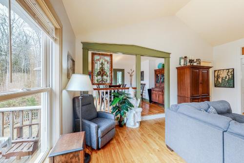 a living room with a couch and a chair at Knickerbocker Lake Retreat in Boothbay
