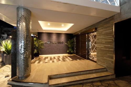 Postel nebo postele na pokoji v ubytování HOTEL555 沼津駅北