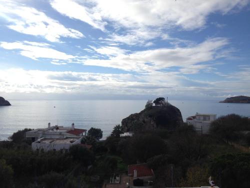 a view of the ocean from a hill with houses at Alkyonis Apartments in Panormos Kalymnos