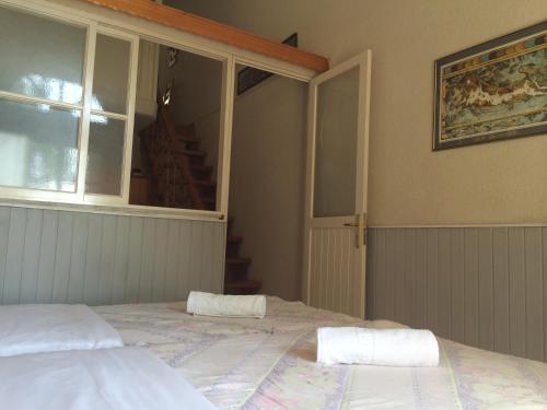 a bedroom with a bed with two towels on it at Alkyonis Apartments in Panormos Kalymnos