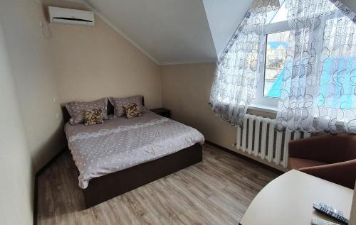a small bedroom with a bed and a window at Hotel Konus in Făleşti