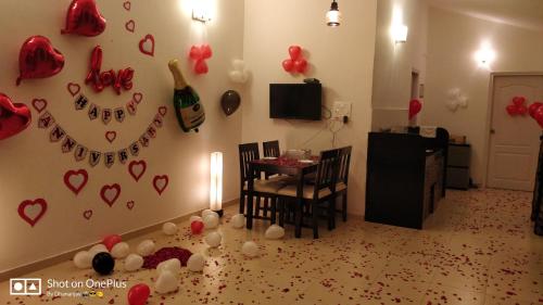 a living room with a table and hearts on the wall at Chalet Casa Amor, Perfect home amidst tranquility in Karjat