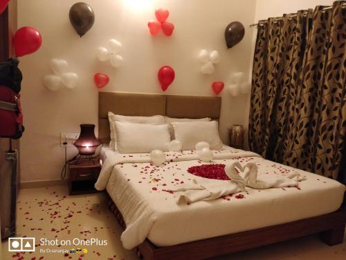 a bedroom with a bed with balloons on the wall at Chalet Casa Amor, Perfect home amidst tranquility in Karjat