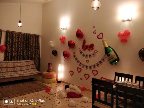 a room with a wall with hearts and a bottle of champagne at Chalet Casa Amor, Perfect home amidst tranquility in Karjat