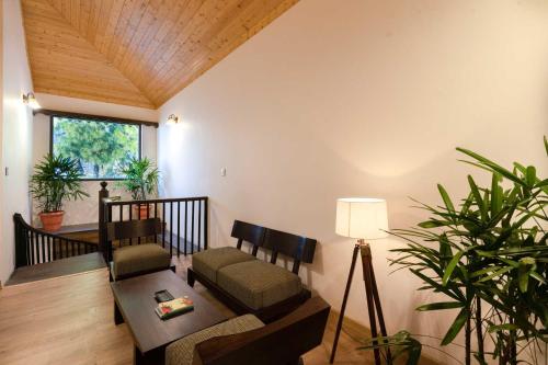a living room with a couch and a table at StayVista at The Winter Line with Complimentary Breakfast in Kasauli