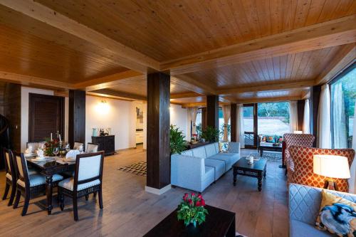 a living room with a couch and a table at StayVista at The Winter Line with Complimentary Breakfast in Kasauli