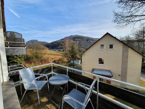 a balcony with chairs and a view of a house at Apartement Willingen in Stryck