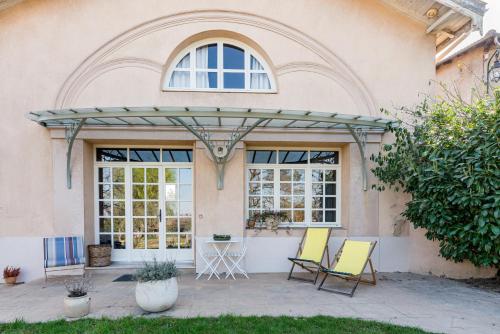 Lancié的住宿－Domaine de la Serve，大楼前带两把椅子的庭院