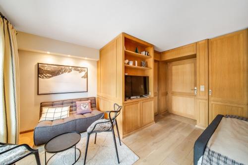 a living room with a couch and chairs in it at Lovely studio in Crans’ center in Crans-Montana
