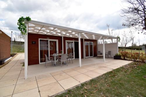 a pavilion with a table and chairs on a patio at Agriturismo B&B Corte Tonolli in Valeggio sul Mincio