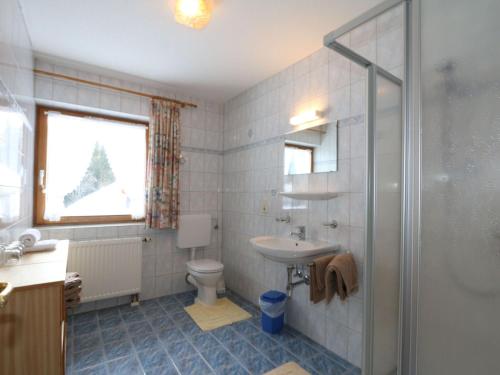 a bathroom with a toilet and a sink and a shower at Apartment in Ischgl overlooking the mountains in Ischgl