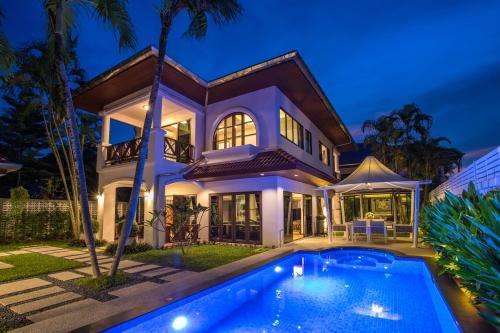 a villa with a swimming pool at night at Best Holidays - Oxygen pool, Billard, Gym! 2-Storey Tropical Villa Havana N in Kamala Beach