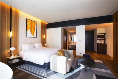 a hotel room with a bed and a couch at voco Seoul Gangnam by IHG in Seoul