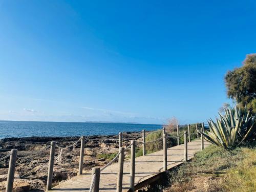 a path leading to the ocean on a beach at Blue House Mallorca in Ses Salines